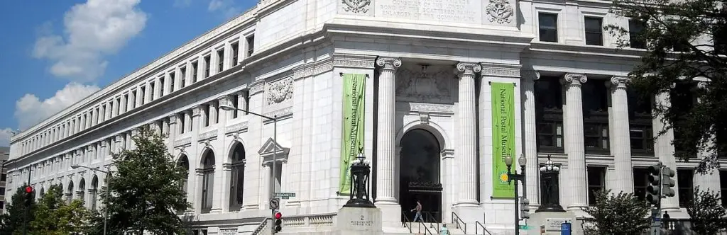 a large white building with green and white trim