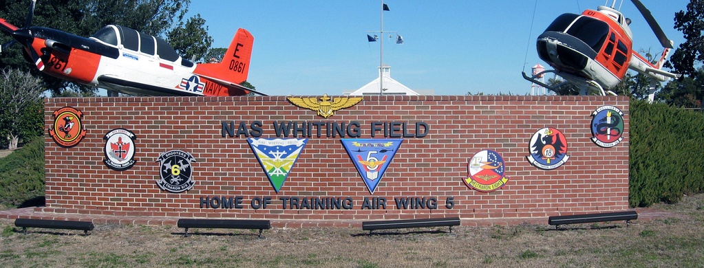 a brick sign with several different types of aircraft on it