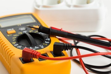 a multimeter and some wires on a table