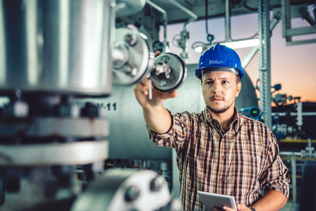 a man in a hard hat holding a tablet