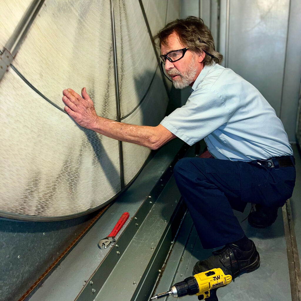 a man is working on a metal structure