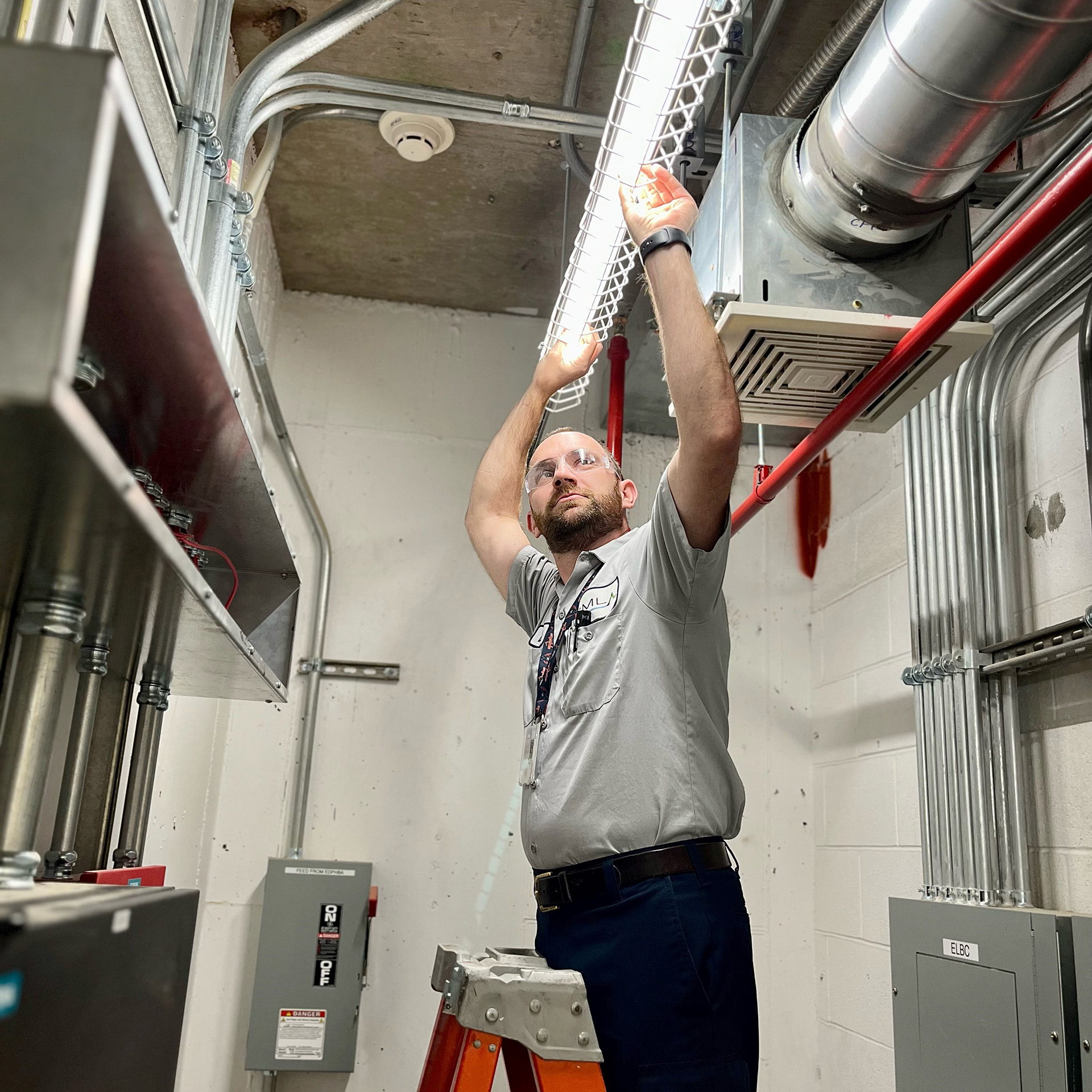 a man is working on a ceiling in a building