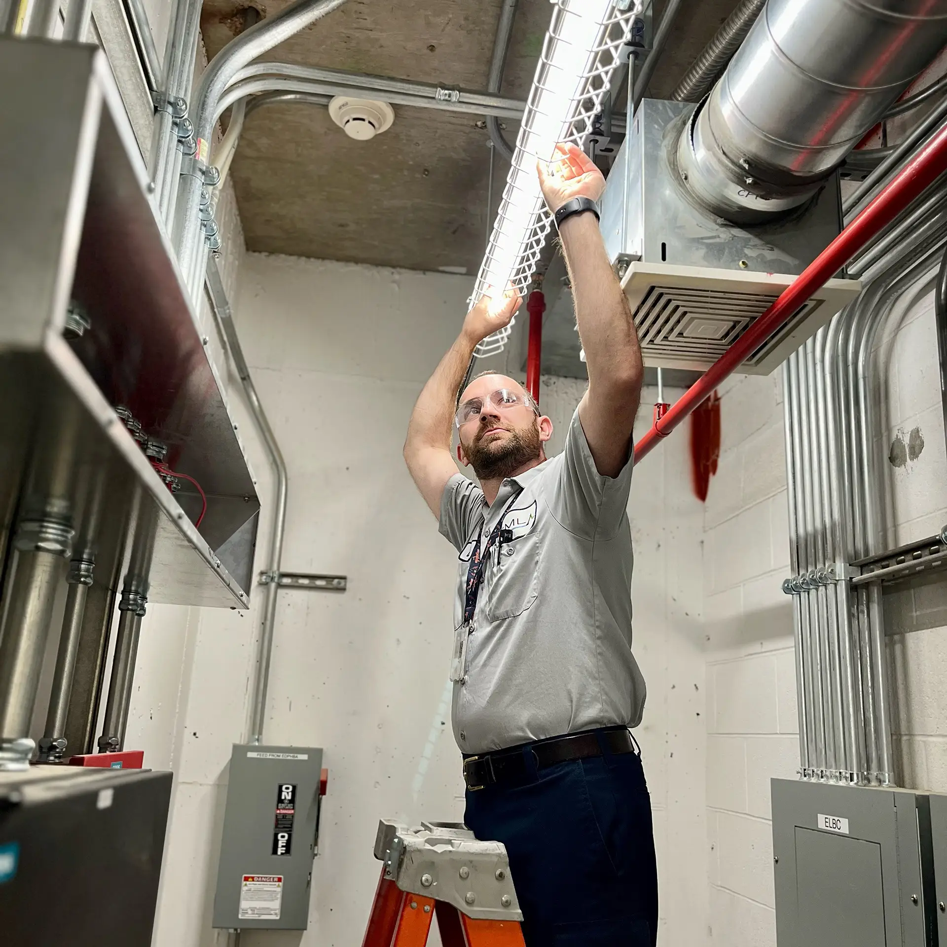a man is working on a ceiling in a building