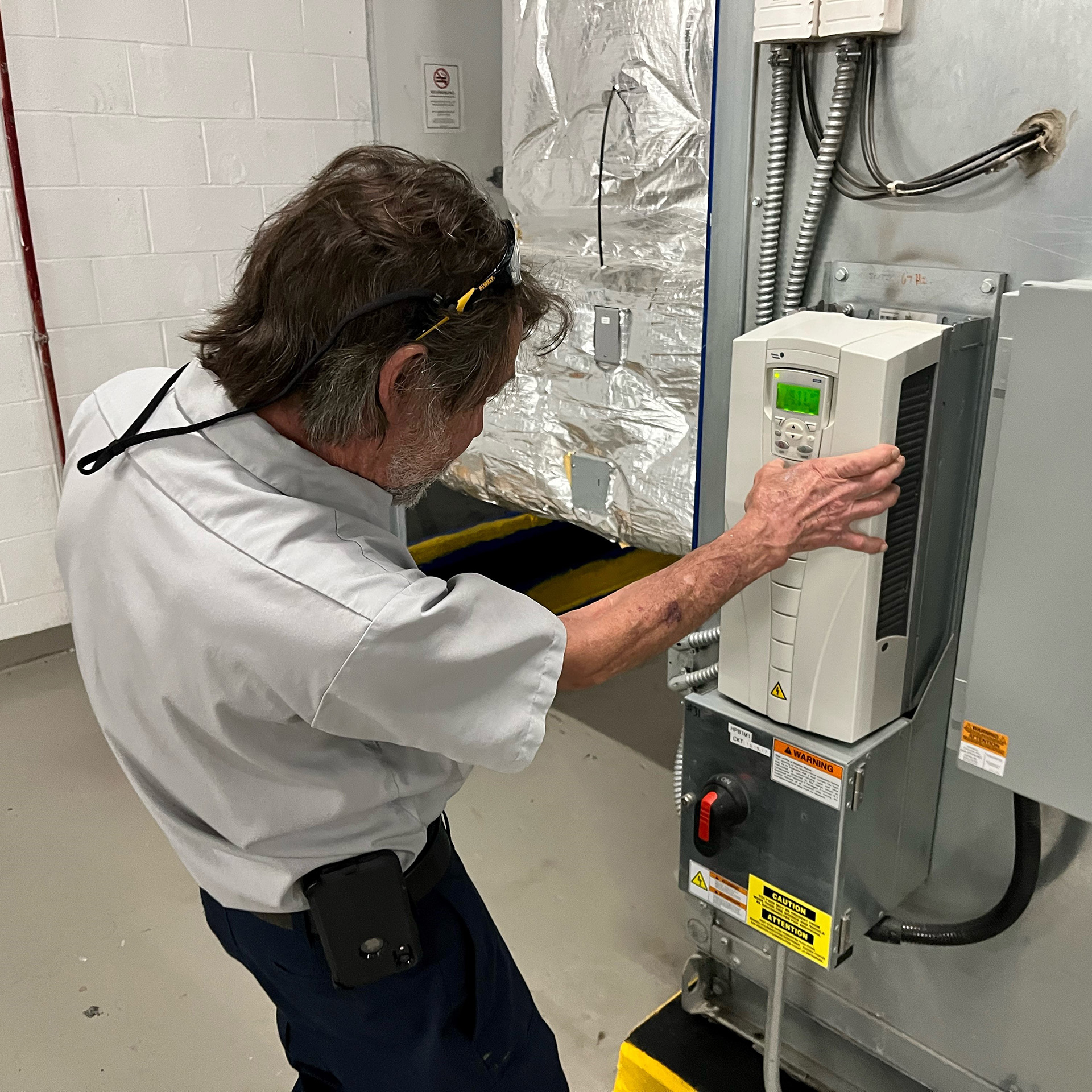 a man working on a machine in a factory