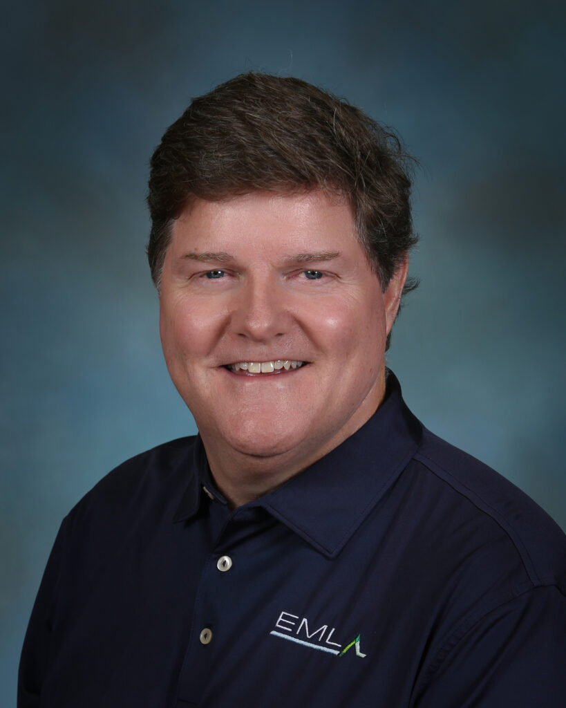 a man in a polo shirt smiling for a picture