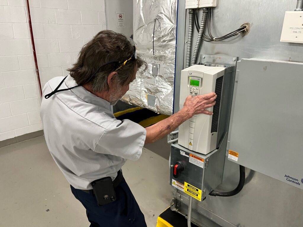 a man working on a machine in a factory
