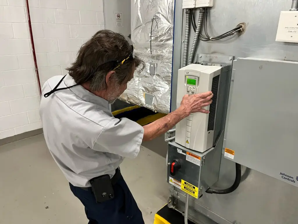 a man working on a machine in a factory